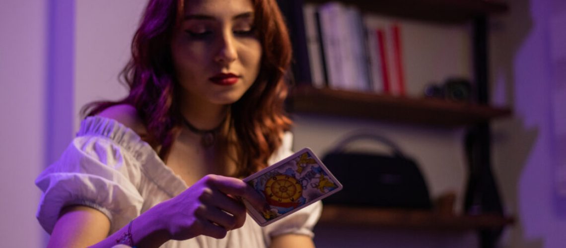 beautiful young woman fortune teller reading tarot